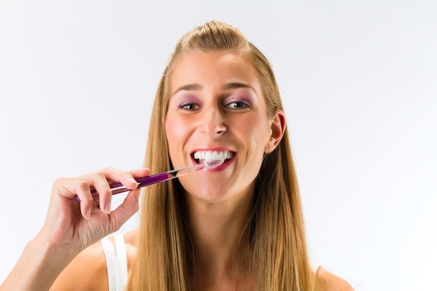 Woman brushing her teeth with toothbrush