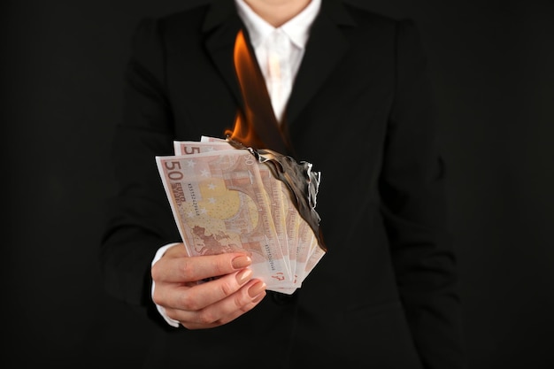 Woman burning Euros closeup