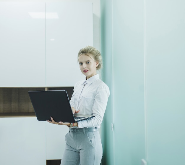 Woman in business clothes with a laptop