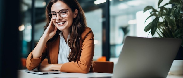 a woman in a business suit is sitting at a desk with a laptop and a laptop