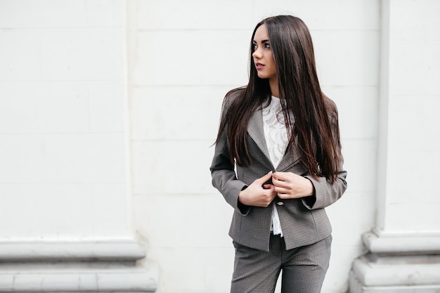 Woman buttoning jacket up