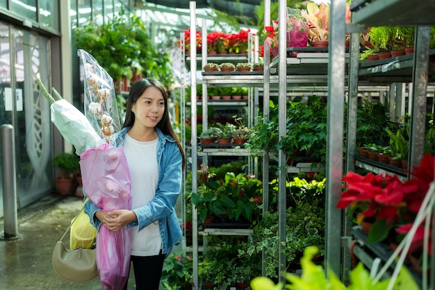 Woman buy flower in the shop