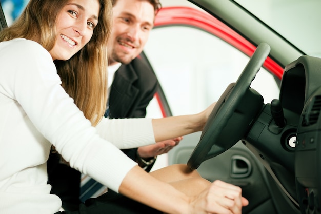 Woman buying car from salesperson