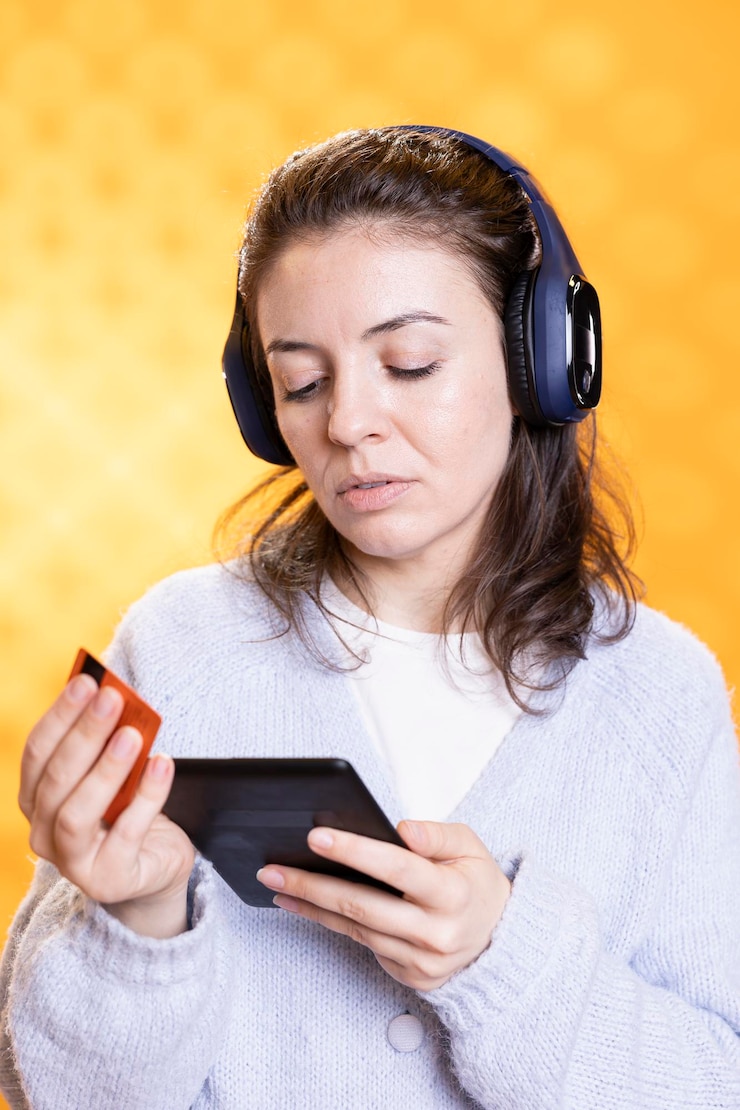 Photo woman buying electronic books for ereader using credit card studio background