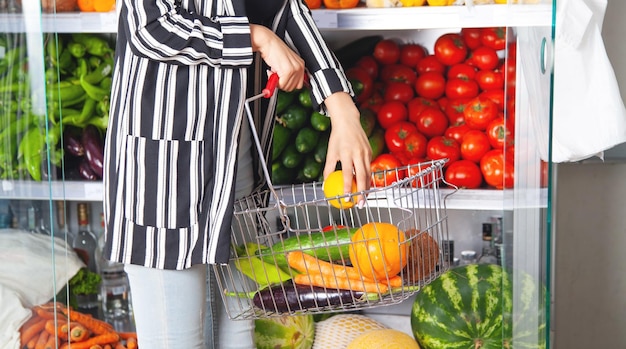 Woman buying lemon at supermarket