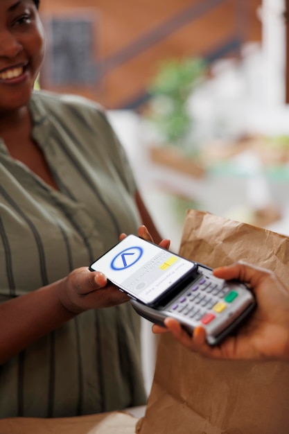 Woman buying produce with mobile payment