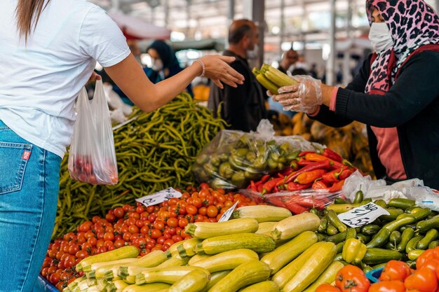 Woman buying vegetables in the market photo