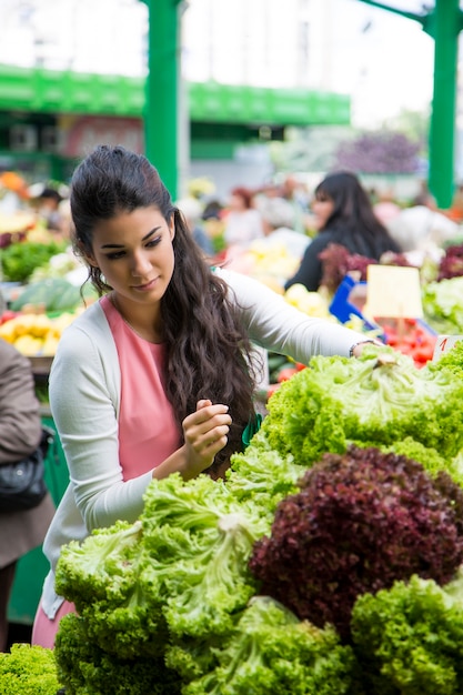 Woman buying vegetables on the market