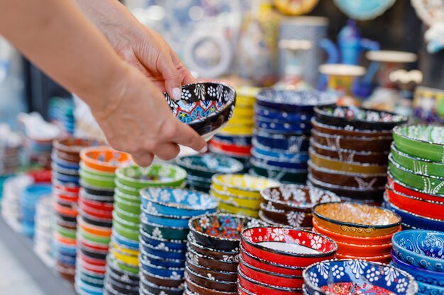 Foto donna compra piatti di ceramica al bazar orientale