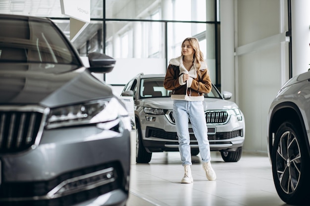 Woman bying a car in a car showroom