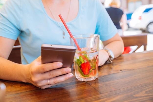 woman in cafe drinking cool drinks close up