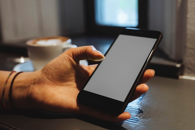 Woman in a cafe using a mobile phone