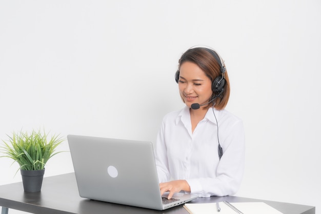 Woman call center sitting at laptop.