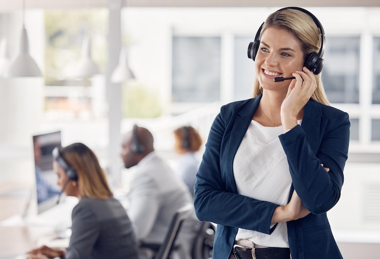 Photo woman call center and smile in leadership with headset for telemarketing customer service or support at office happy female consultant manager smiling with headphones for online advice or coaching