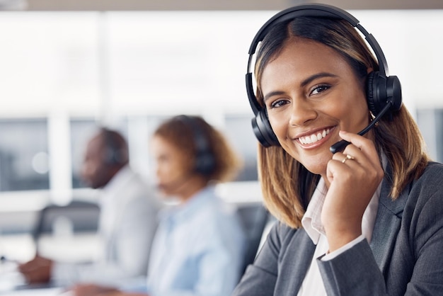 Photo woman call center and smile with headset mic for telemarketing customer service or support at the office portrait of happy female consultant agent smiling with headphones for online advice or help