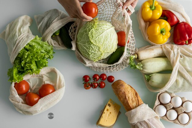Woman came back from a market and unpacks a reusable grocery bag full of vegetables on a kitchen