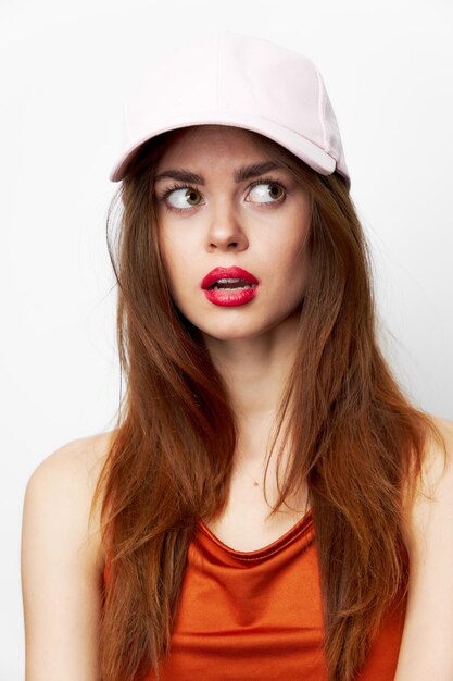 Woman in a cap looks to the side with open mouth attractive look cropped view