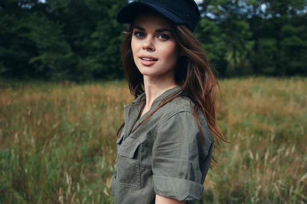 Woman in a cap on the meadow and green shirt