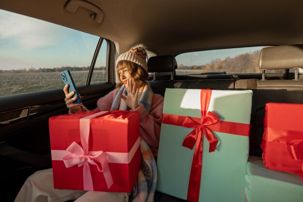 Woman in car with christmas presents