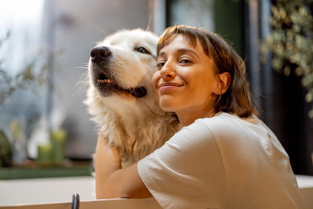 Woman cares her cute dog while washing in bathtub