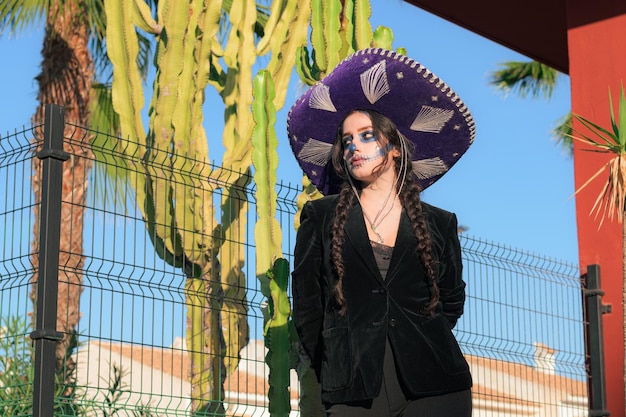 Woman in carnival mask for a traditional Mexican holiday of the day of the dead outside