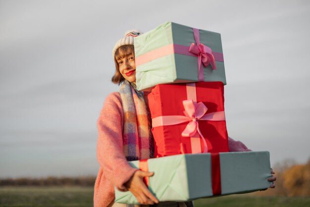 Woman carries new years gifts outdoors