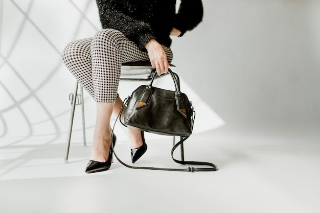 woman carrying a black shoulder bag