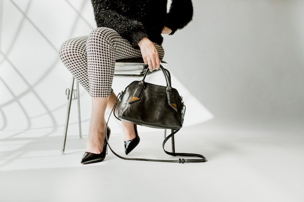 Woman carrying a black shoulder bag