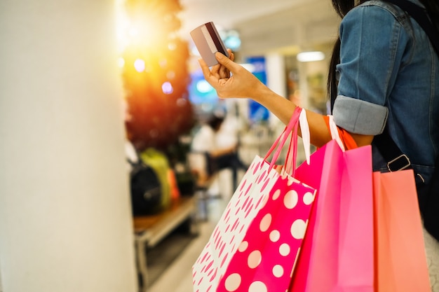 A woman carrying shopping bag and walking in the department store 