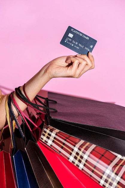 Woman carrying shopping bags and a credit card