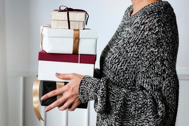 Woman carrying a stack of presents