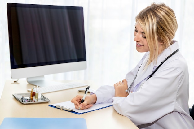 Woman Caucasian doctor examination and checking reports in the hospital room.