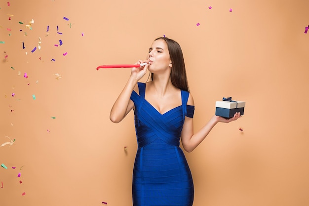 The woman celebrating birthday on brown background