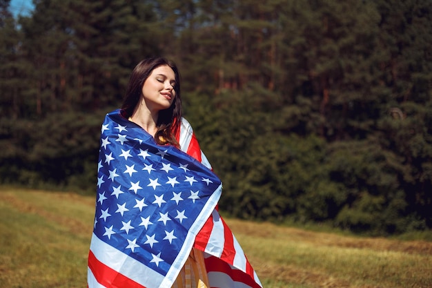 Woman celebrating independence day and hold american national flag