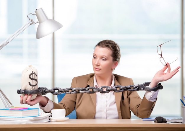 Woman chained to her working desk