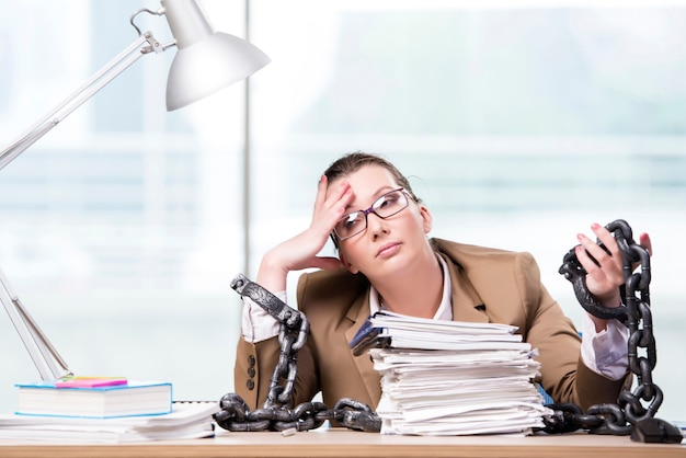 Woman chained to her working desk