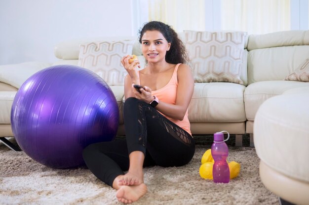 Woman changing channel at home