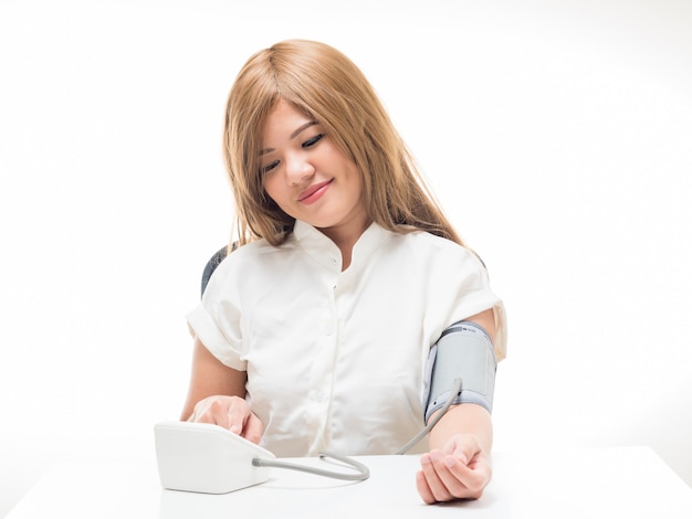 Woman checking blood pressure on white background