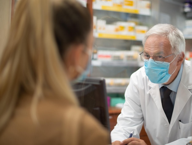 Woman checking out in a pharmacy coronavirus concept