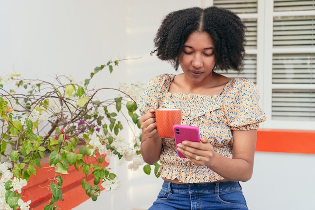 Woman checking phone during coffee break