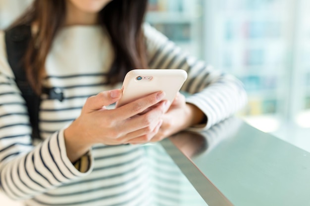 携帯電話で何かをチェックしている女性