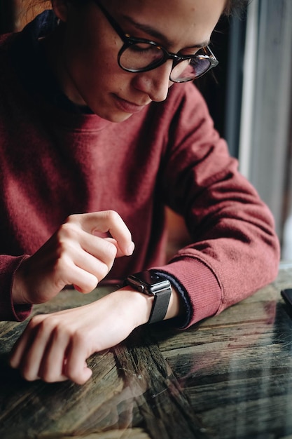 woman checking time at table