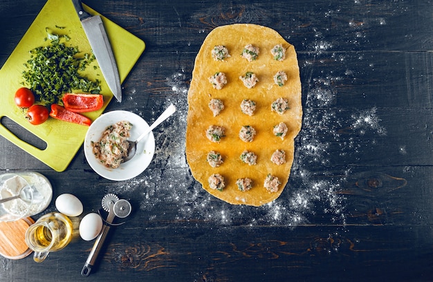 Woman chef cooks step by step the traditional ravioli