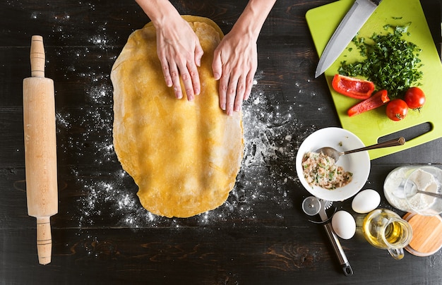 Woman chef cooks step by step the traditional ravioli