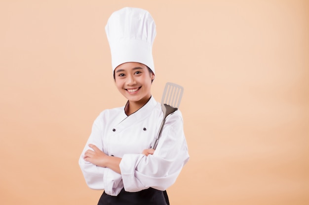 woman chef holding spatula cooking equipment