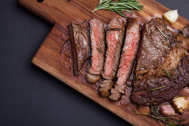 The woman chef is preparing a beef steak.