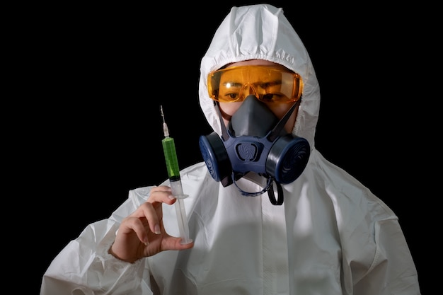 Woman in chemical protective clothing and antigas mask with glasses at white background