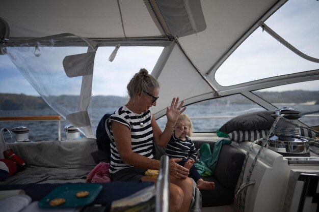 Photo a woman and a child are on a boat with the word  on the side