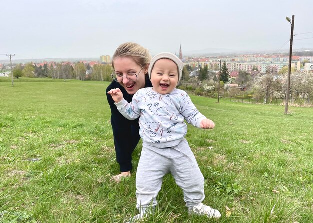 Foto una donna e un bambino stanno giocando nell'erba