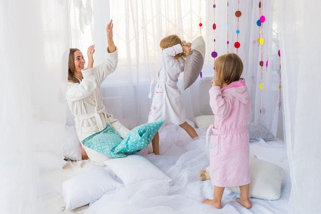 Woman and children on bed